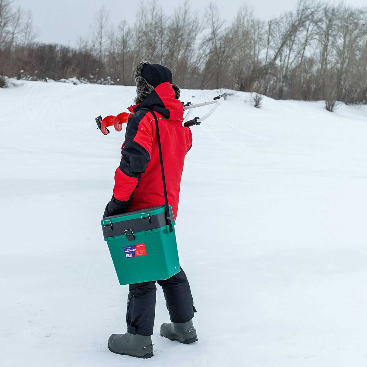 An angler carrying the Ice Fishing Bucket Type Box with Seat and Adjustable Shoulder Strap | 2 compartments | 5 gal | green color