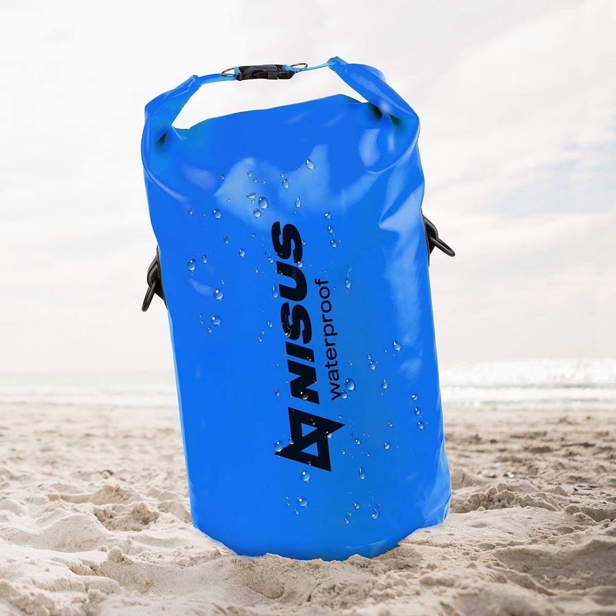 30 L Blue Waterproof Compact Dry Bag standing on the sand