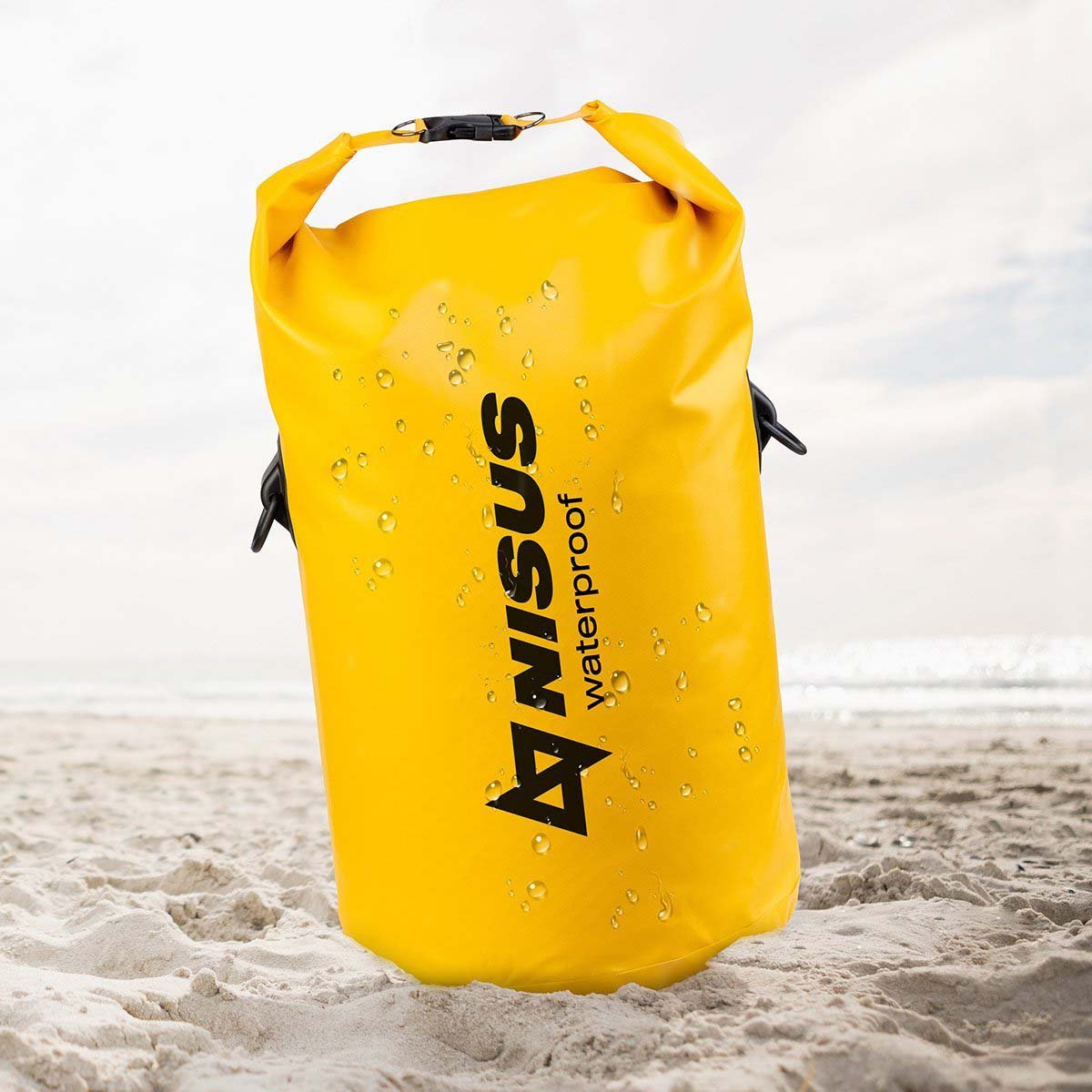 50 L Waterproof Spacious Dry Bag, Yellow standing on the sand
