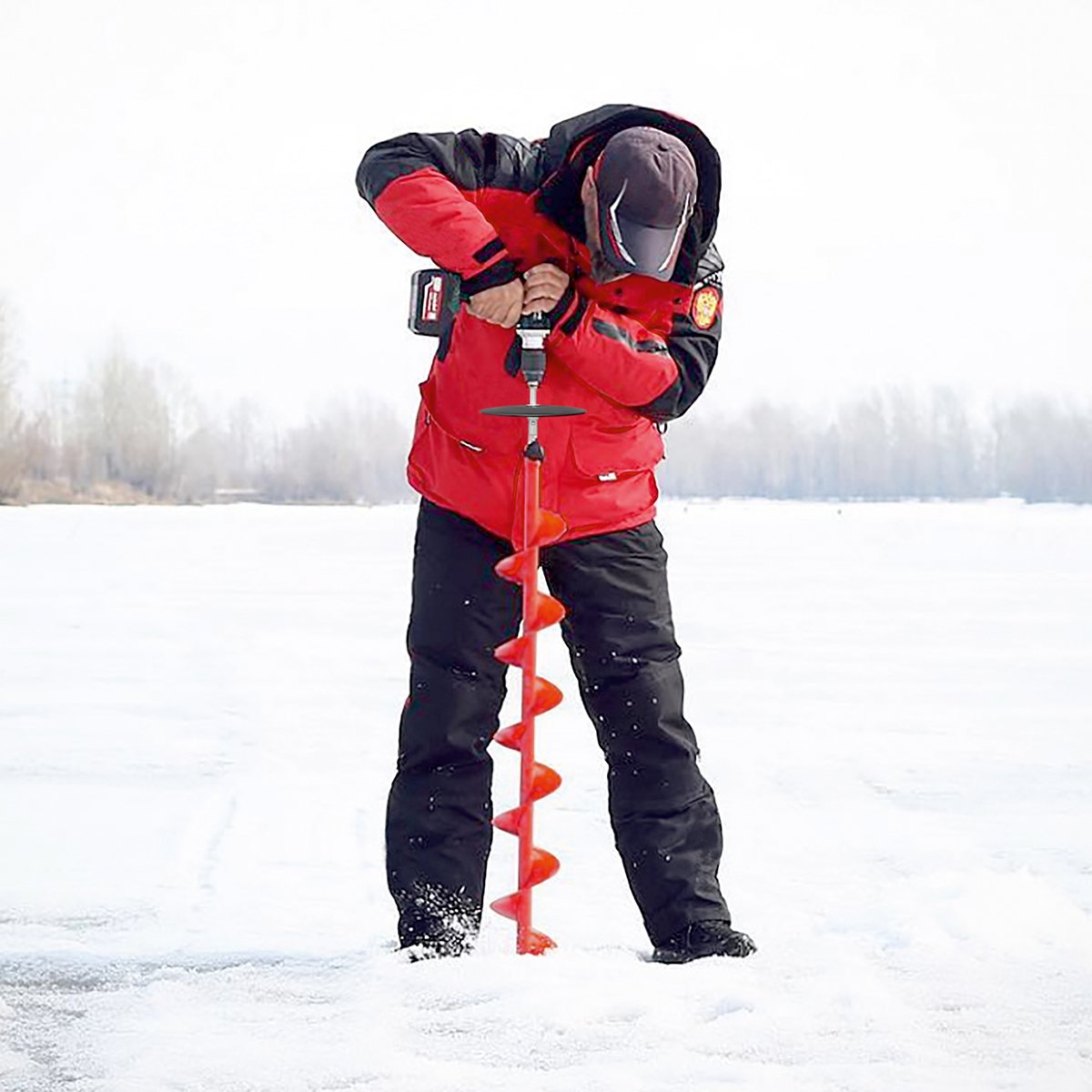 A man using Buran Ice Auger with a cordless drill and ice auger drill adapter wiith a safety plate