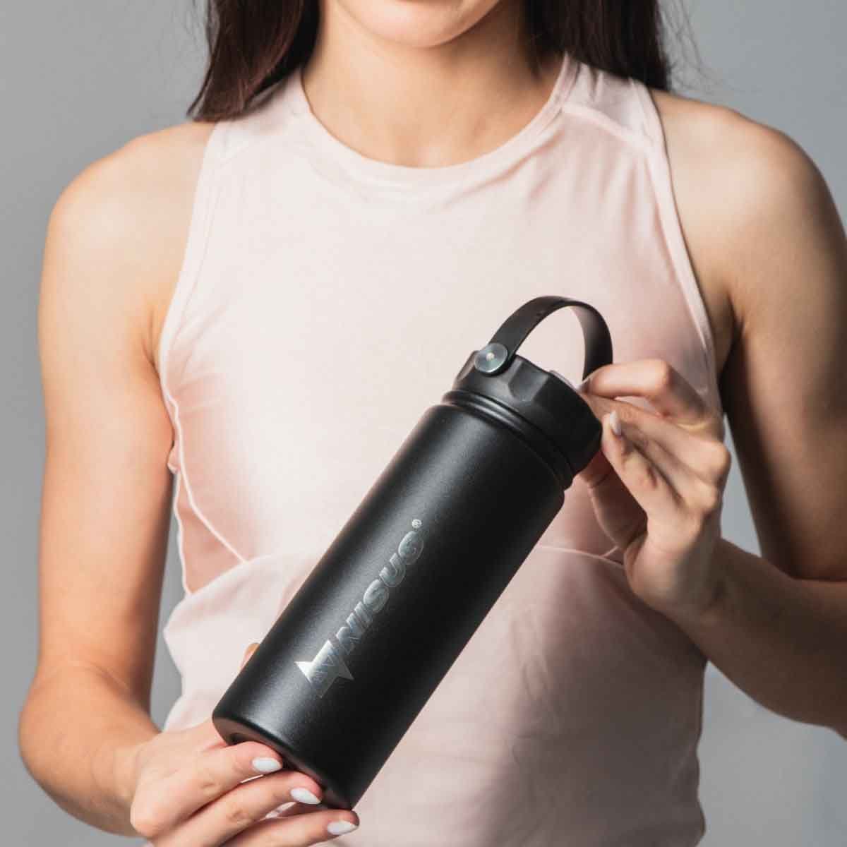 A girl holding the Stainless Steel Insulated Sport Water Bottle with 3 Lid Types, 18 oz, Black