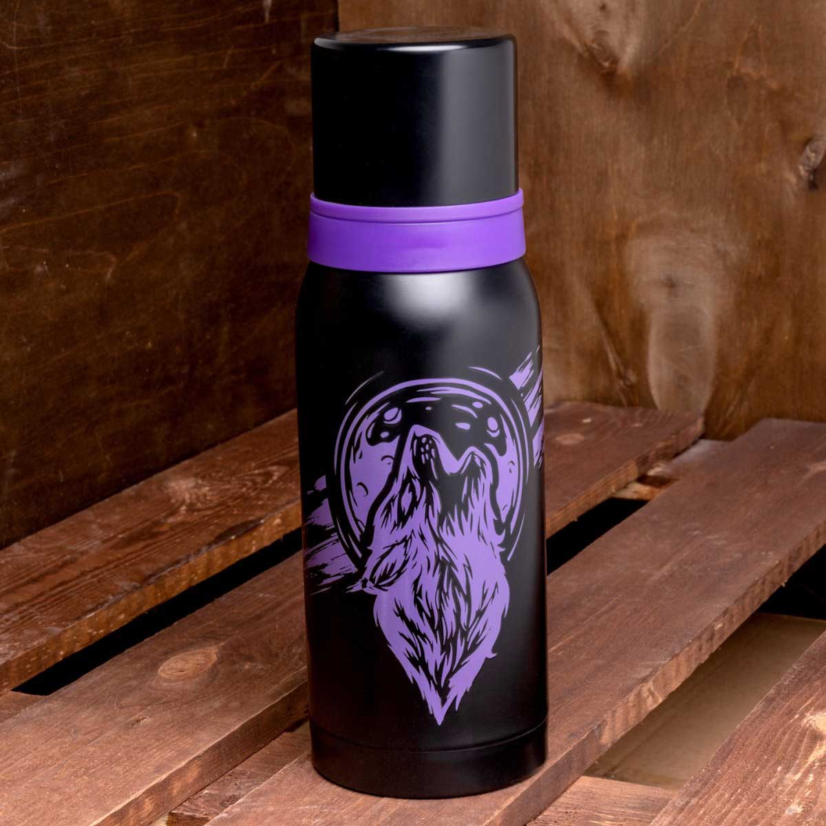 Compact Stainless Steel Water Flask, Wolf Print, 33 oz standing on a wooden bench