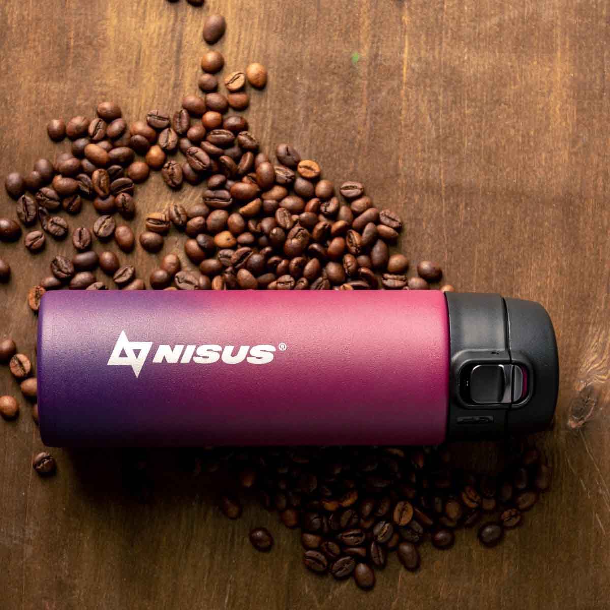 Compact Stainless Steel Insulated Water Bottle, Red, 14 oz laying on the kitchen table with the coffee beans.