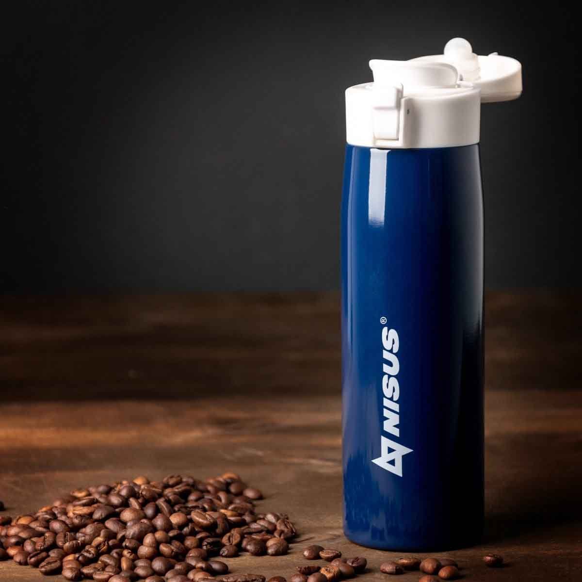 Push Button Lid Water Bottle, Stainless Steel, 16 oz, Blue, standing on the kitchen table with coffee beans