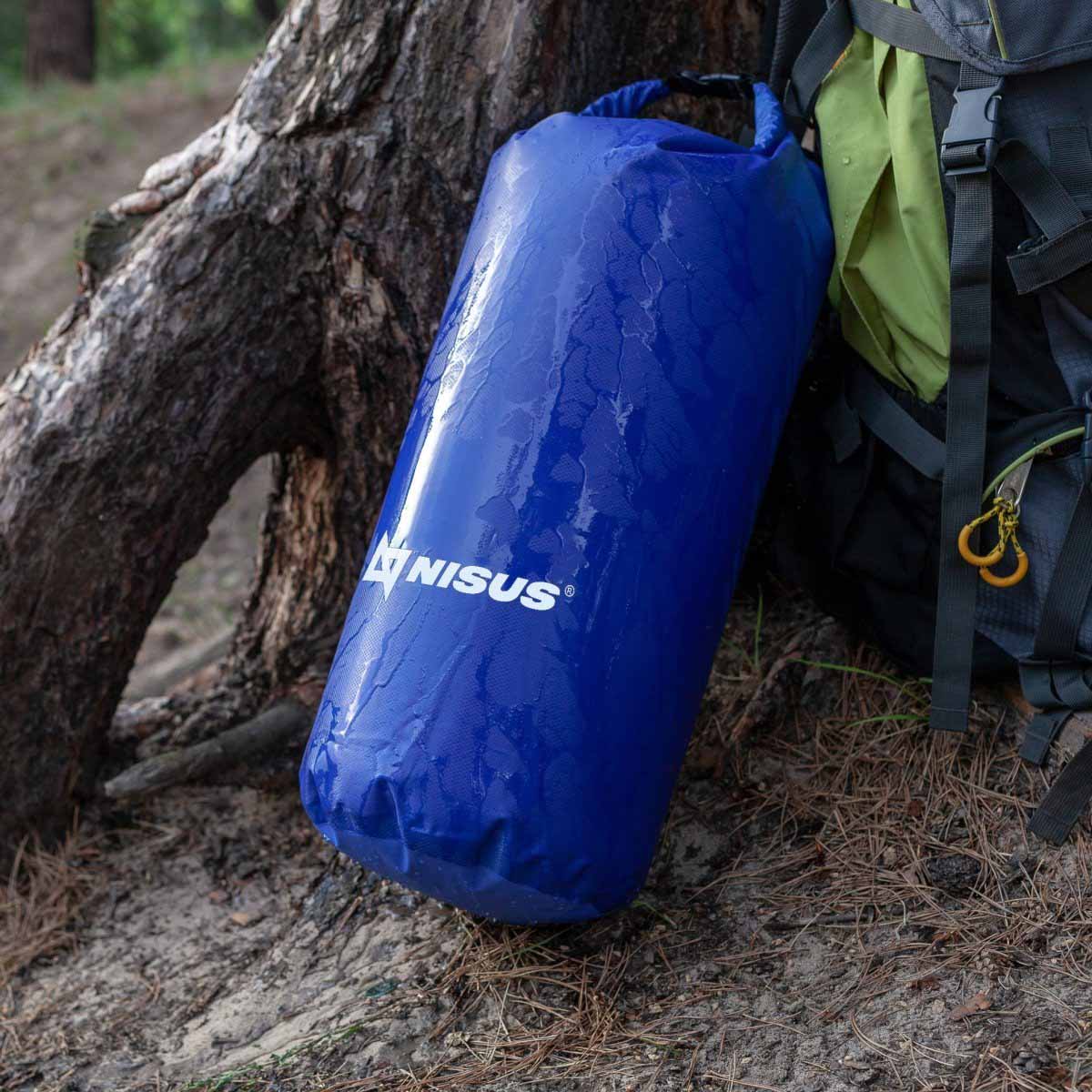 20 L Blue Polyester Waterproof Dry Bag for Fishing, Kayaking staying near the tree