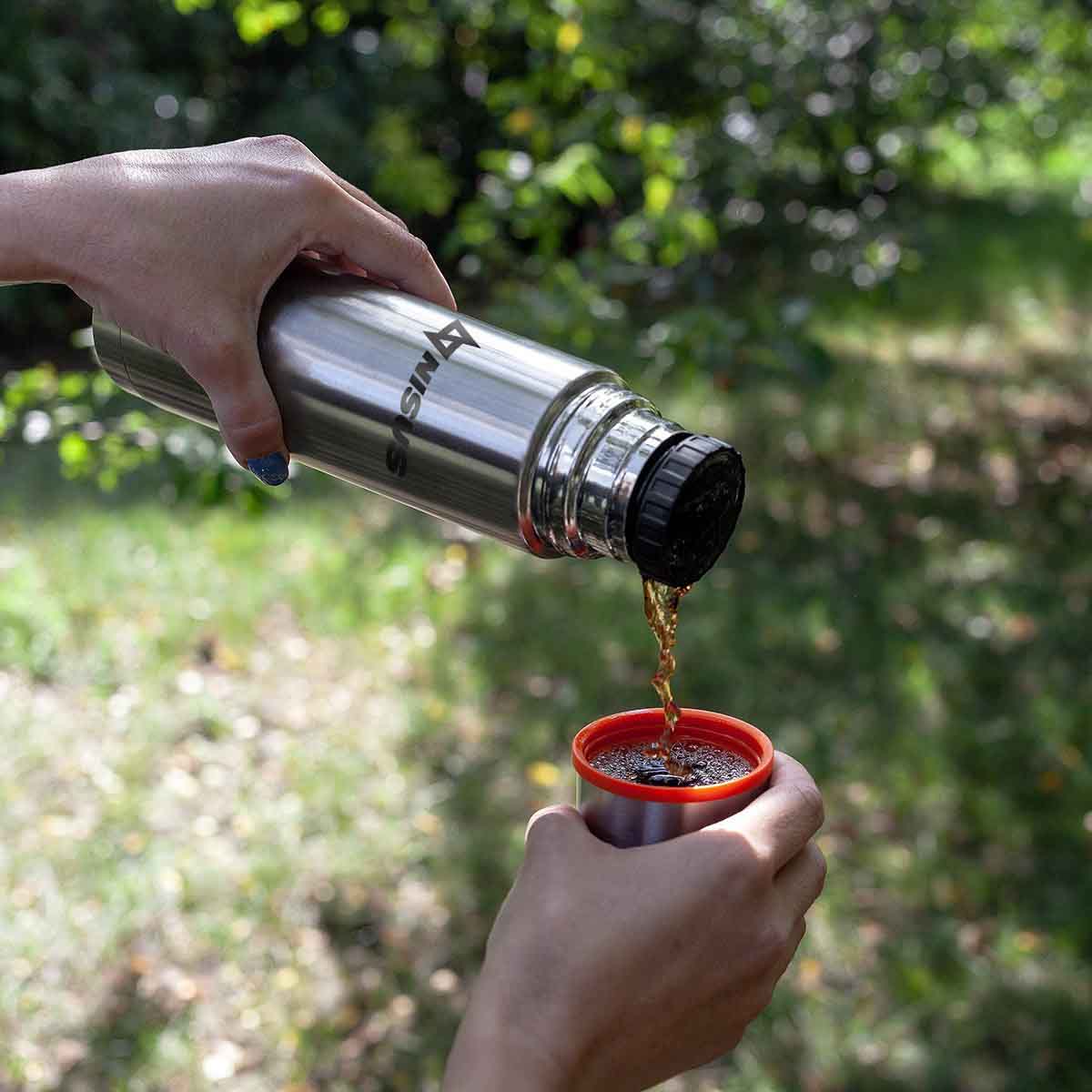 A girl pouring the drink out of the Portable Stainless Steel Vacuum Flask into Lid Cup
