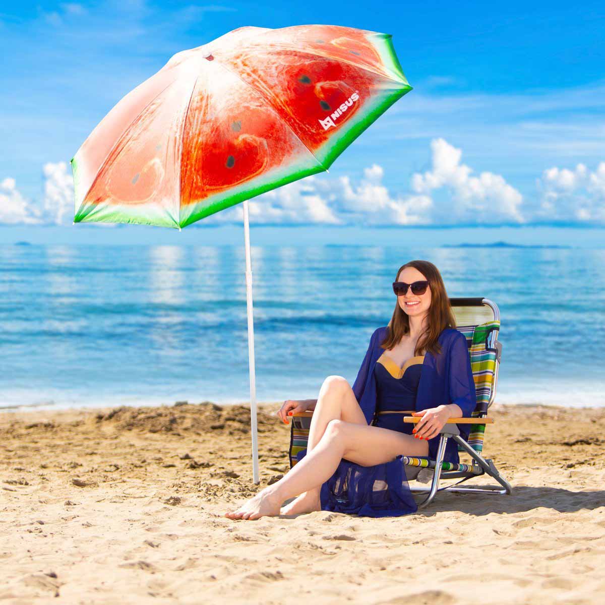 A girl sitting on the Backpack Beach Chair with Headrest under the watermelone beach umbrella