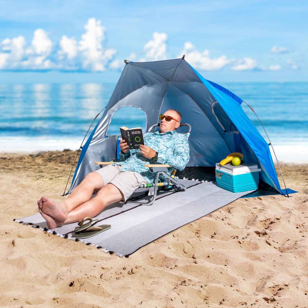 A man reading book sitting on the chair in a 2 Person Easy Up Beach Tent Sun Shade Shelter UPF 50+