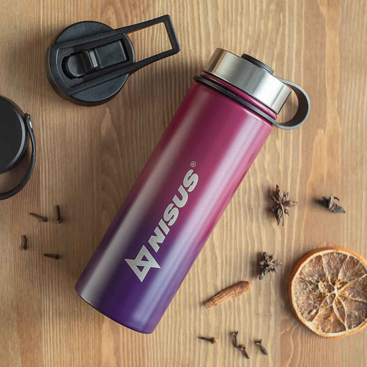 Stainless Steel Water Bottle with 3 Lid Types, 18 oz, Double Colored laying on the kitchen table