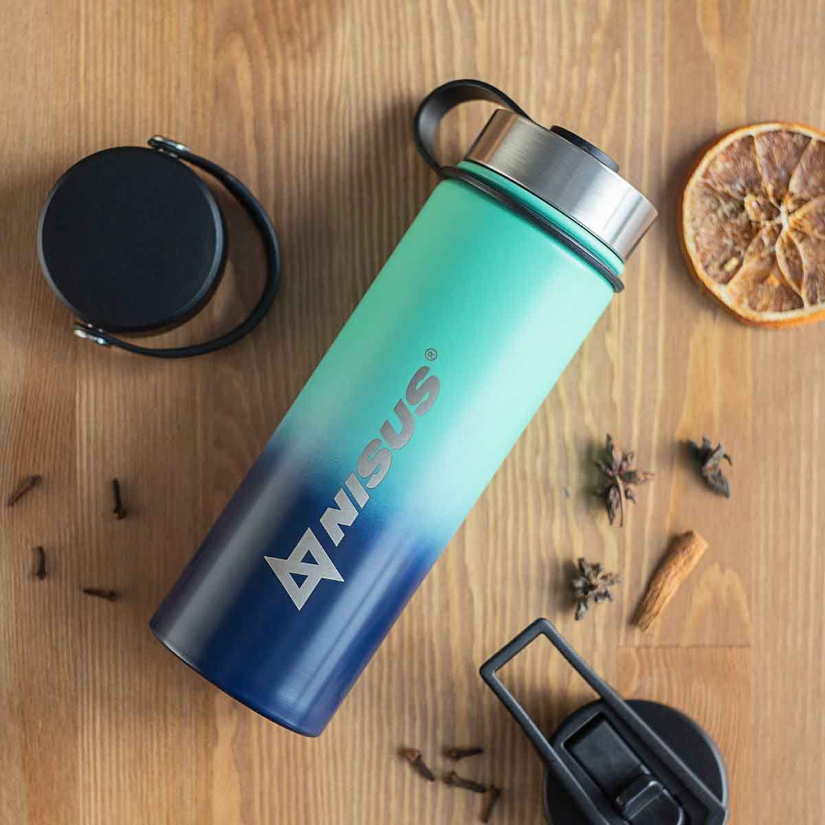 Stainless Steel Water Bottle with 3 Lid Types, 18 oz, Double Colored laying on the kitchen table