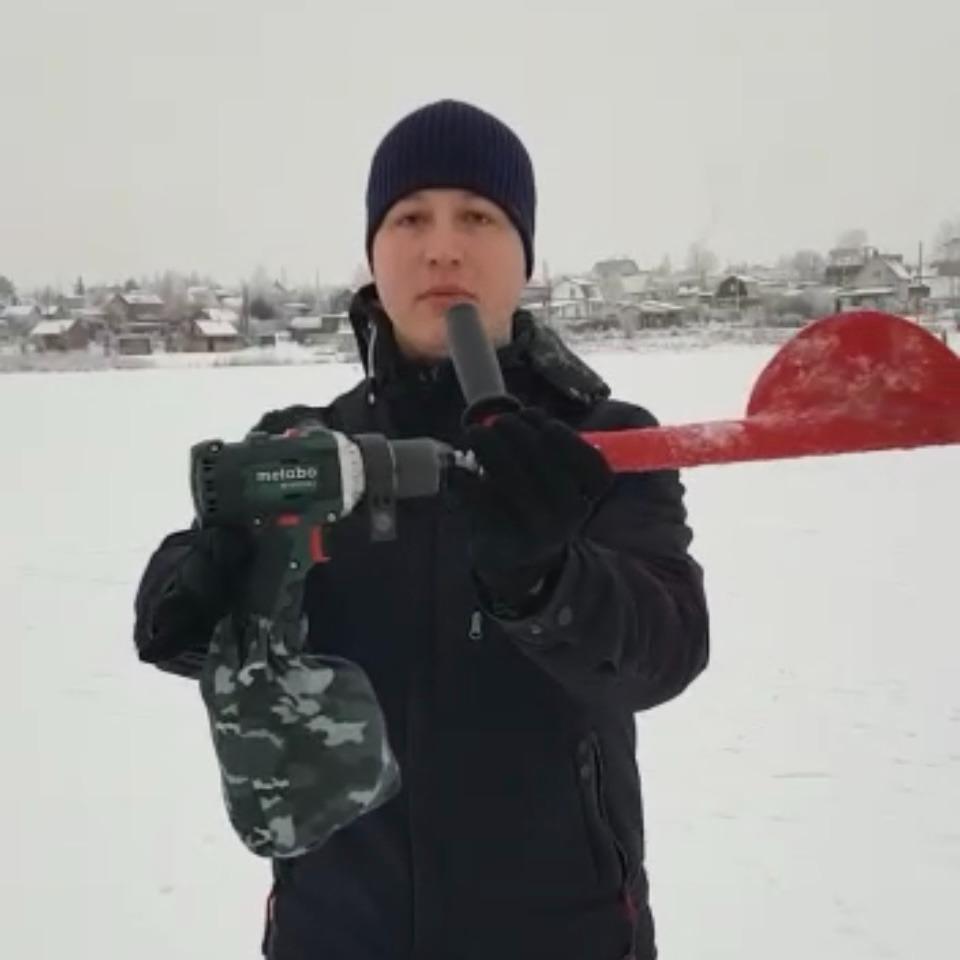 A man using BURAN Professional Ice Fishing Hand Auger with a cordless drill